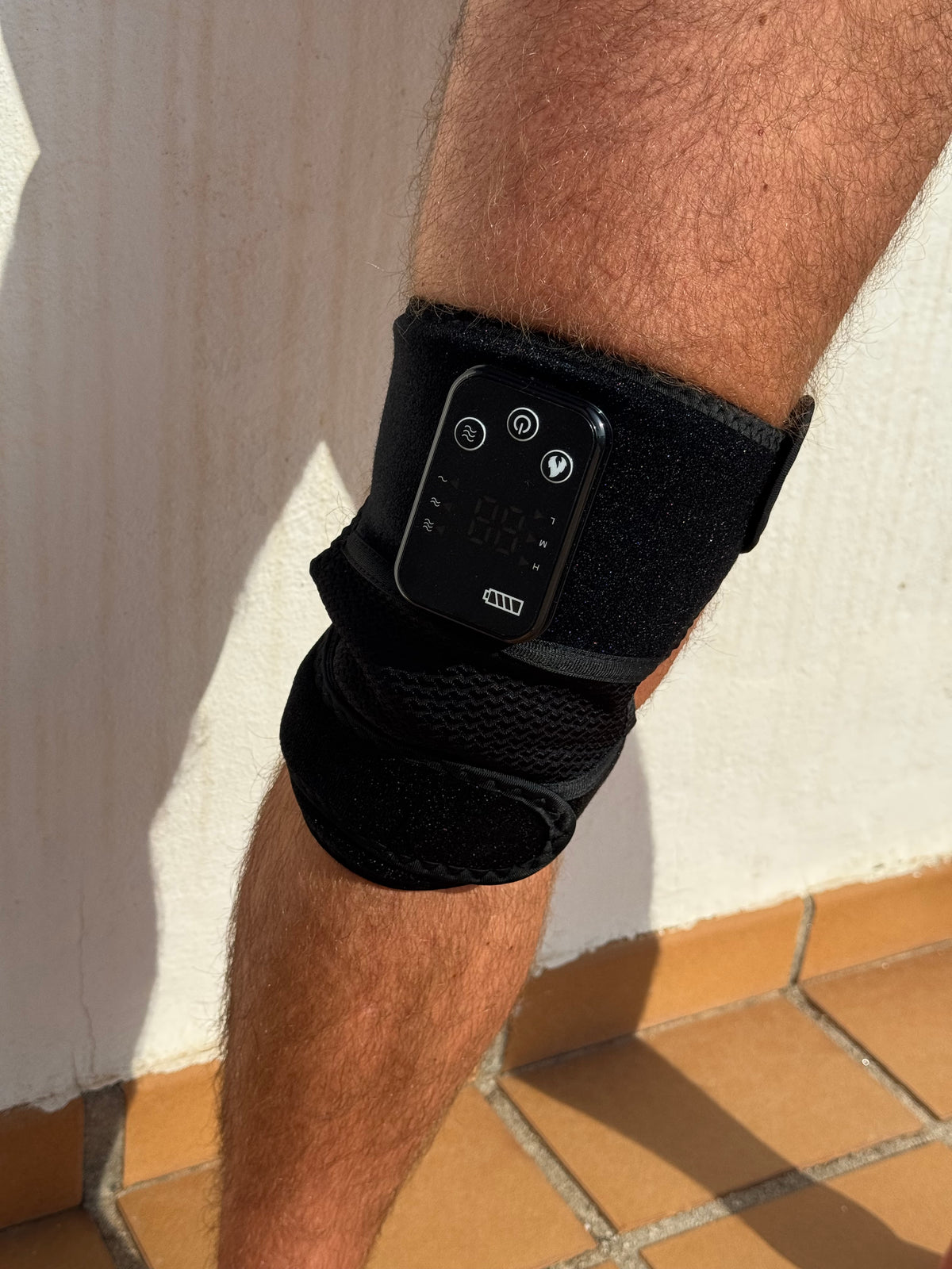RecoverWave Knee Wrap Pro side view on leg, real product photo